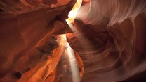 shafts of light stream thru canyon